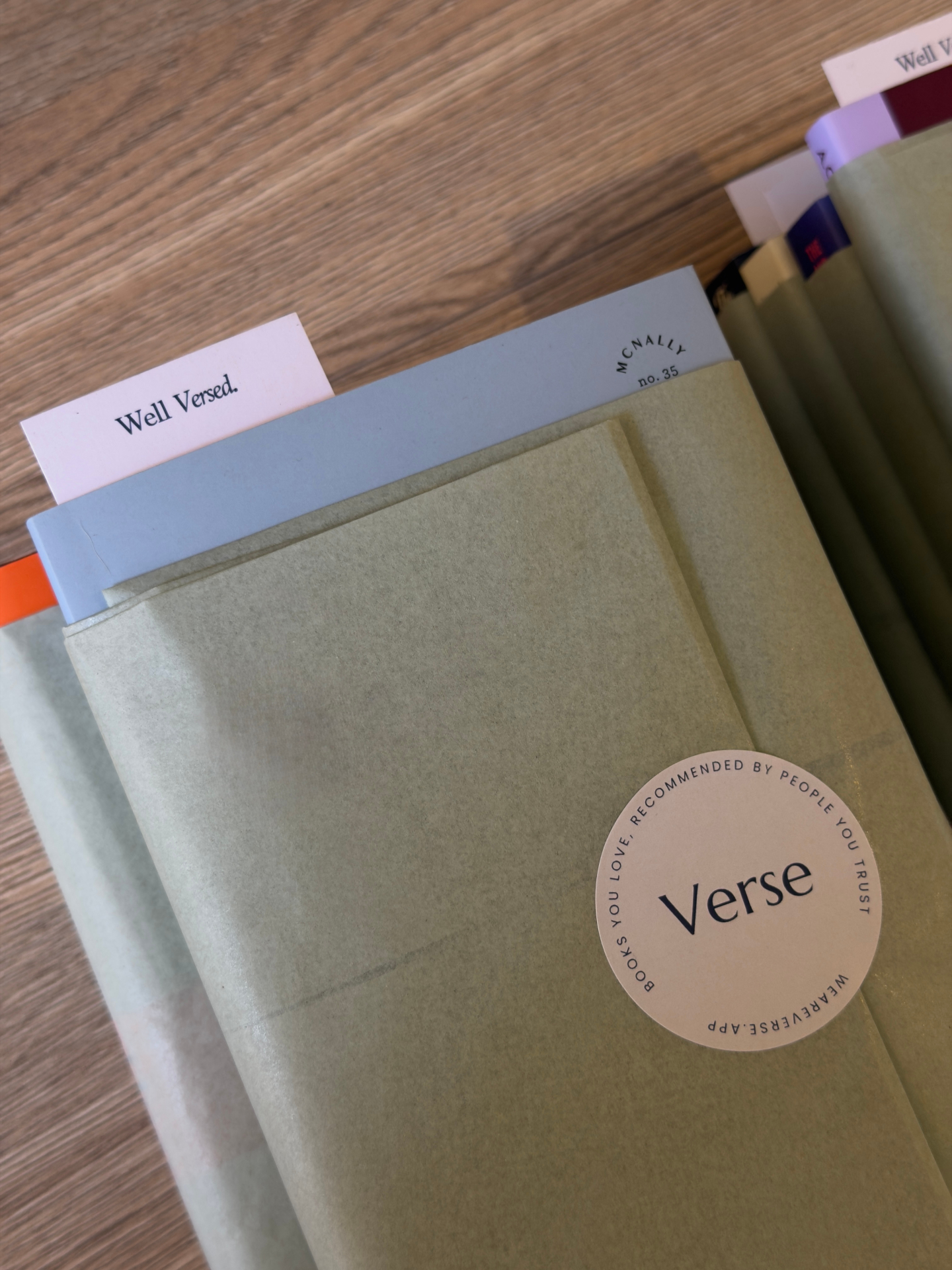 A Verse parcel wrapped in sage tissue paper with the round Verse sticker